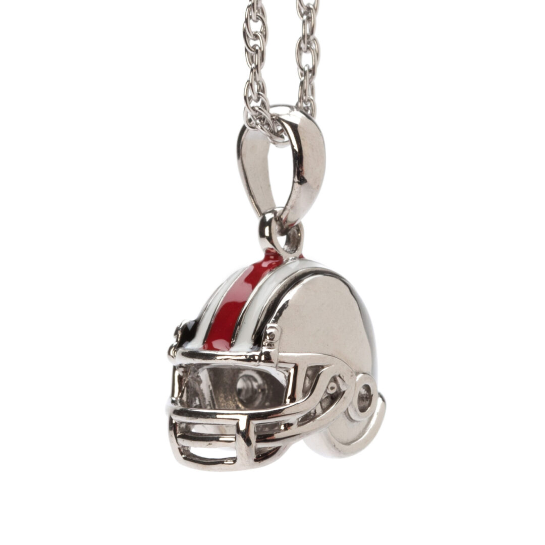 A silver necklace with a football helmet on it.