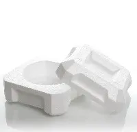 Two white plastic containers on a white surface.