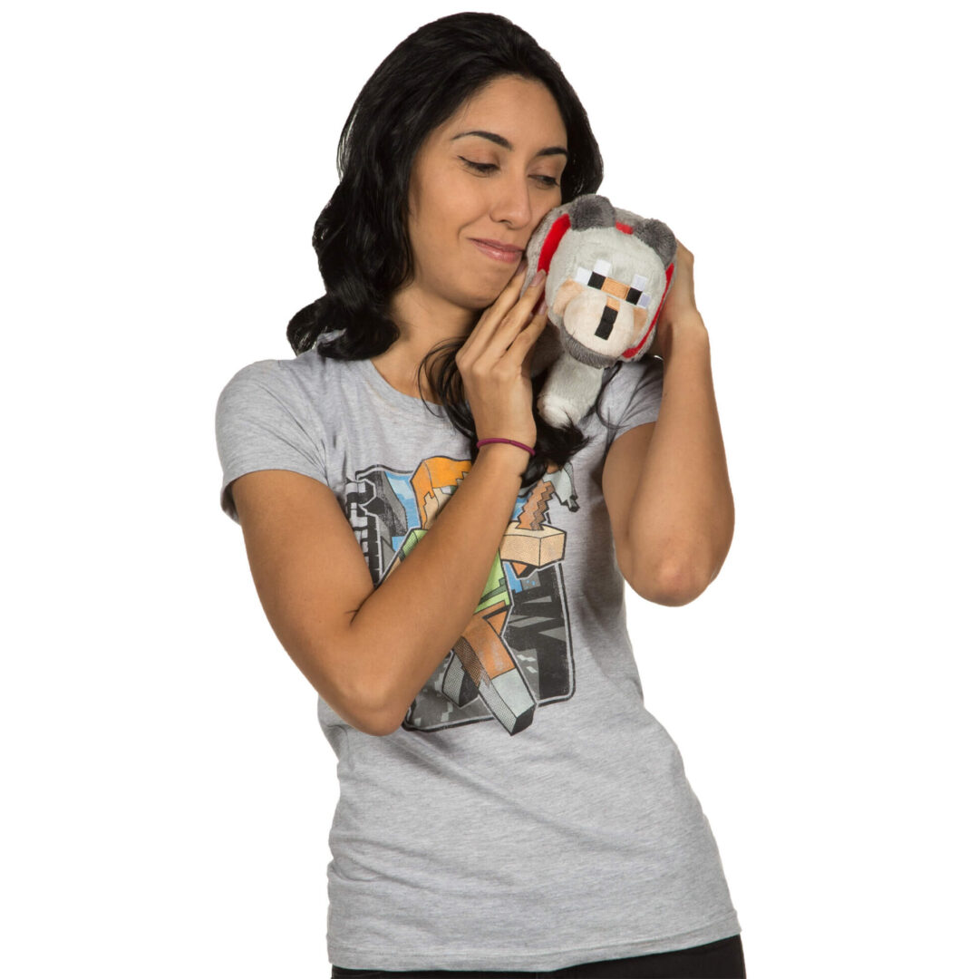 A woman is holding a stuffed animal in her hands.
